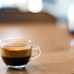 selective focus photography of a cup of black coffee