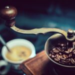 selective focus photography of vintage brown and gray coffee grinder