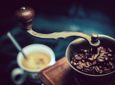 selective focus photography of vintage brown and gray coffee grinder