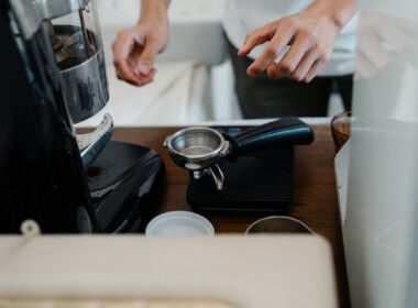 crop barista preparing coffee by using portafilter