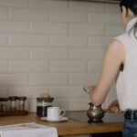 backside of a woman making coffee